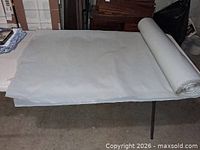 Roll of clear plastic sheeting unrolled on table