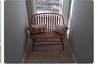 Front view of wooden bench positioned between walls