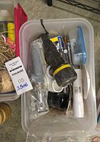 Plastic bin with flashlight, fittings, nozzle, hardware