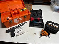 All three tools with their respective cases and manual