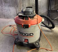Full view of RIDGID wet/dry vacuum with hose and cord