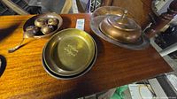 All pieces on table: covered dish, bowls, scoop