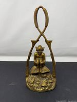 Full view of brass door knocker showing overall design and crossed handles