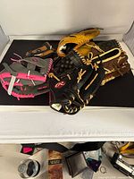 Five gloves stacked showing colours, Rawlings logo, Dura-Bond marking