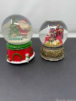 Two snow globes side by side