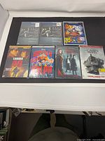 Seven sealed DVD cases laid out