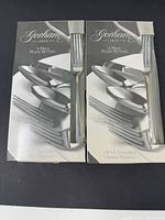 Front view of two Gorham 5-piece place setting boxes