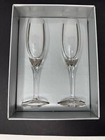 Two crystal fluted champagne glasses inside presentation box