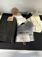 Group shot of all hats and gloves with tags