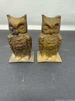 Front view of both brass owl figurines showing design and condition