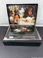 Open box showing interior film-stills lid and shrink-wrapped contents sheet