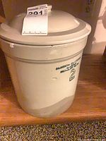 Full view of crock with lid and tag visible