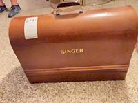 wooden dome case with Singer logo