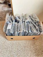 Box holding 27 packages of grips