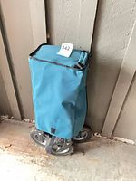 Wagon folded inside blue canvas cover
