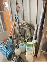 Group view of tools, hose, fencing rolls, sprayers, ice melter