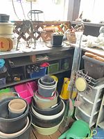 overview of stacked pots, plant stand, wind chime, accessories on shelving