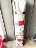 Full view of Ventura gazebo in carry bag leaning against wall