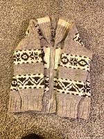 Sweater folded showing front zipper, collar and pattern bands