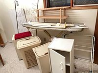 Overview of all laundry accessories including ironing board, hampers, cabinet, racks and shelf