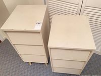 Two white 3-drawer bedside chests side by side