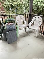 white and green chairs, lounger and cushions on porch