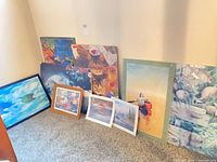 group shot of all prints and mounted puzzles leaning against wall