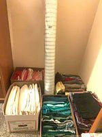 Five boxes of quilting fabrics in various colours with vertical striped fabric roll