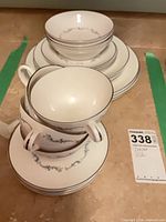 Stacked china showing bowls, plates, cups and saucers