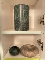 Overview of three stone items on shelf