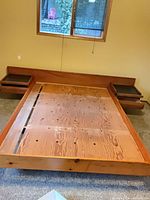 Full view of teak headboard, nightstands, and pine frame