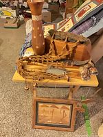 Overall lot on TV tray showing vase, box, macrame, mobile, art and shells