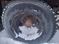 Side view showing tire size marking 11R22.5 on sidewall mounted on rim