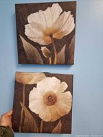 Both canvas prints displayed on blue wall