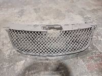 Front view of black plastic diamond mesh grille