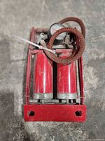 Top view showing dual red cylinders, gauge, hose, foot frame