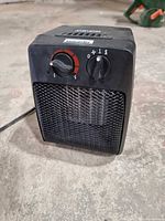 Front view of Lancaster space heater showing mesh grille, thermostat dial, mode selector