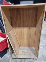 Full view interior of wood rack showing casters and shelf peg holes