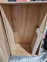 front view of empty cabinet body, shelf tracks visible