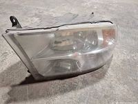 Front angle of headlight showing lens, reflector and overall condition