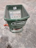 Full view of Scotts handheld spreader showing hopper and logo