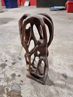 full view of vertical abstract wood sculpture