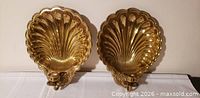 Front view of both brass shell sconces