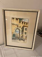 Full view of framed watercolor in light neutral frame