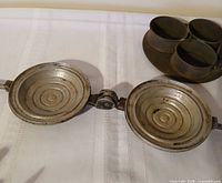 Open view of cast aluminum pie iron showing ridged 5 in plates