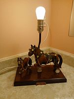 Front view of Gilbert Clydesdale horse lamp with bulb lit