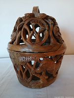 Full view of carved wooden bowl with lid in place