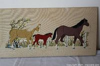 Full view of stitched horse scene on canvas