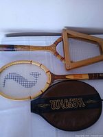 Both racquets, press frame and Wilson cover overview
