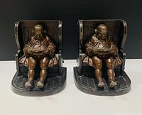 Front view of both bronze bookends showing seated man figures